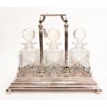 A Walker & Hall silver plated three decanter holder, including three cut glass decanters s/d,