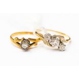 Two 18ct gold and diamond rings, one with a cross over design illusion set with three diamonds,