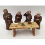 Bretby figurines of four monks drinking ale, one standing,