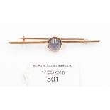 A star sapphire bar brooch set in unmarked yellow metal but tests as 9ct gold,