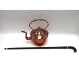 A copper kettle and an ebonised carved walking stick (2)