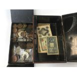 A cash tin, late 19th Century, early 20th Century with a quantity of coins and banknotes,