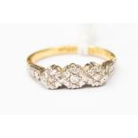 A diamond ring, illusion set with three small diamonds in 18ct gold, size J,