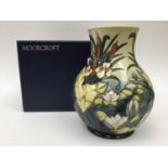 A Moorcroft vase, signed Rachel Bishop. Lamia Vase 95. In original box. 23cms high.