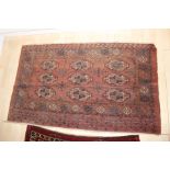 Two Persian rugs, one used as wall hanging,