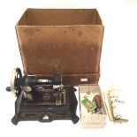 An early 20th Century Muller hand sewing machine, complete with box,