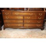 A Georgian style mahogany dresser base, the top with two short drawers and a central drawer,