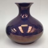 A Moorcroft purple luster bulbous vase (restored rim)