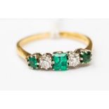 An emerald and diamond ring,