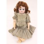 Doll: A bisque head doll, open and close eyes, open mouth revealing four top teeth,