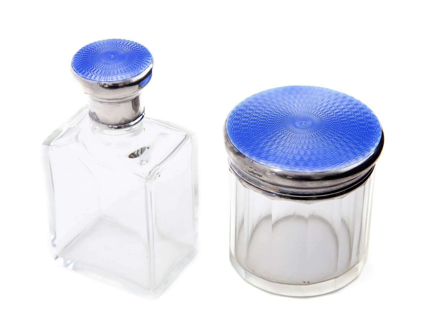 Two Art Deco enamelled silver glass bottles, blue guilloche, Cole Brothers, London 1931 and 1932,