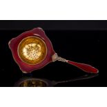 Kristian Hestenes, a Norwegian silver gilt and enamelled tea strainer, Secessionist style,