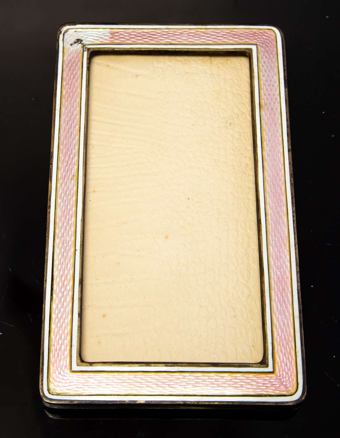 An enamelled photograph frame, pink guilloche enamel within white stripes, 13.