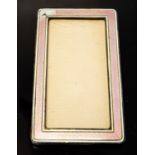 An enamelled photograph frame, pink guilloche enamel within white stripes, 13.