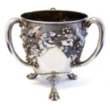 An Art Nouveau silver three-handled cup, egg form embossed in high relief with fruiting vine,