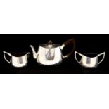 A Modernist silver three piece tea set, ovoid form with wishbone handles, and hardwood finial,