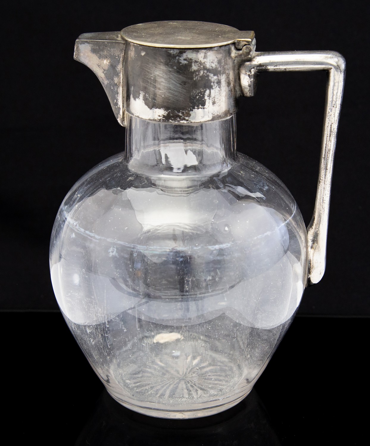 After Christopher Dresser, a silver plated and glass claret jug,