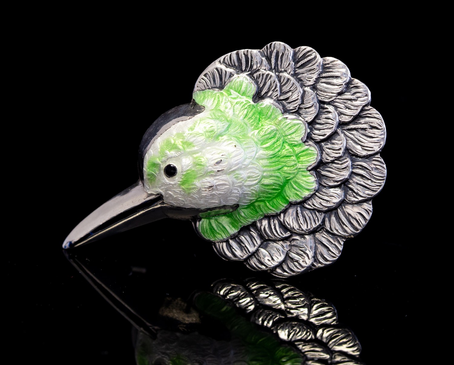 A silver and enamelled hummingbird brooch, circa 1940s, modelled as a birds head,