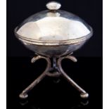 An Arts and Crafts silver plated covered bowl, the squat ovoid body on tripod base united by a ring,