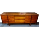 Dyrlund, a Danish rosewood sideboard, circa 1970s, the central bay of five drawers,