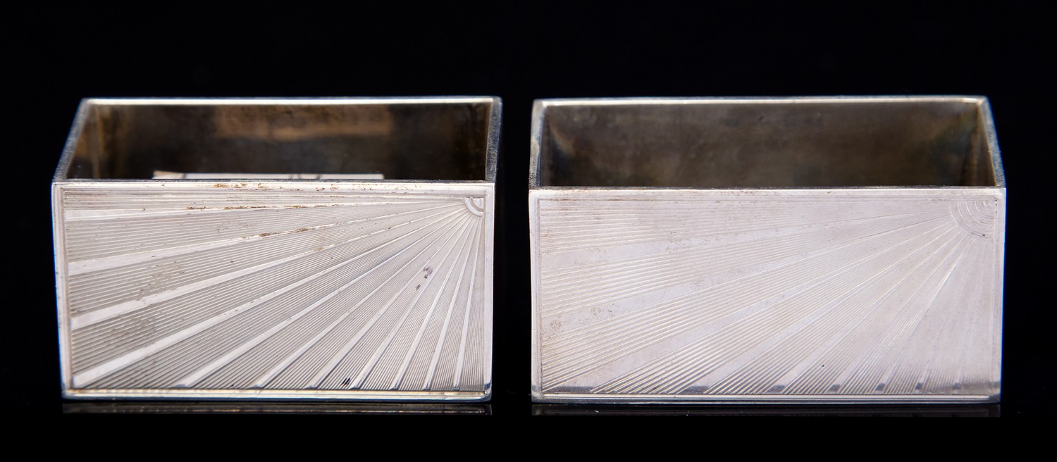 A near pair of Art Deco silver napkin rings, rectangular,