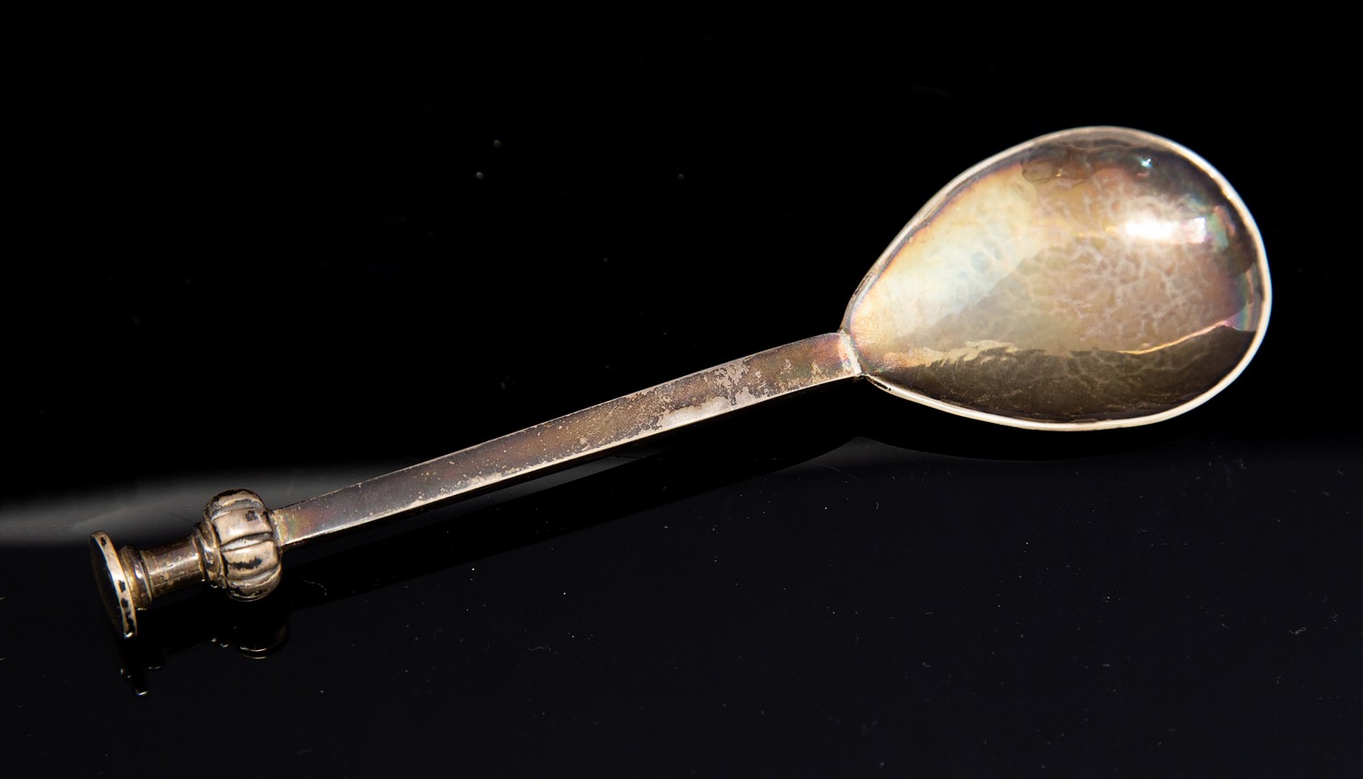 Guild of Handicraft, an Arts and Crafts seal top spoon, hand hammered, reeded knop finial,