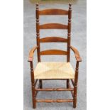 Ernest Gimson, a pair of yew wood ladder back and bobbin turned armchairs, rush seats,