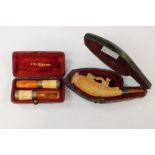 Butterscotch amber and meerschaum cheroot holders and carved pipe,