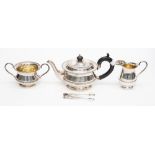 A George V silver three piece tea service, including teapot, sugar bowl and milk jug,