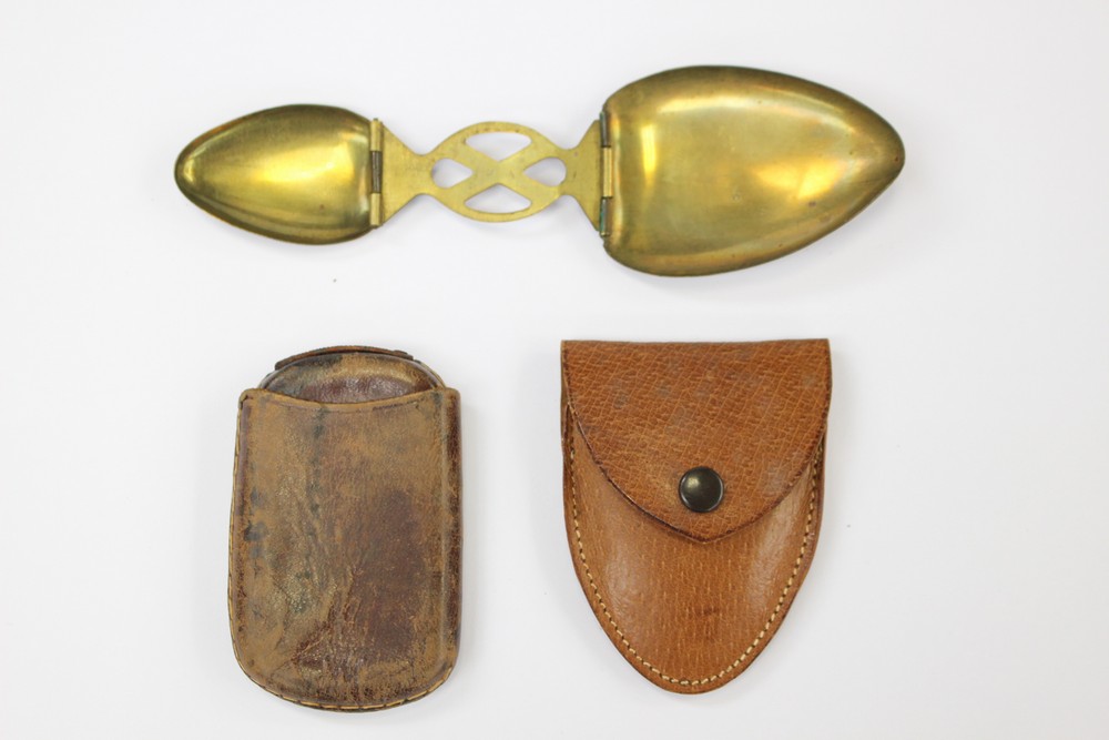 An early 20th Century travelling/folding spoon in pigskin case and another leather case (2)