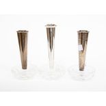 A set of three Elizabeth II silver posy vases on cut glass bases,