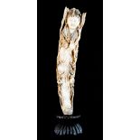 A 19th Century Chinese ivory tusk carving of a robed and jewelled lady holding a branch of flowers,