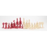 A 19th Century Indian carved bone chess set, natural and stained red,