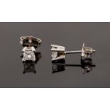 A pair of diamond stud earrings set with princess cut diamonds in 14k white gold,