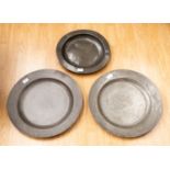 Two large antique pewter chargers with London touchmarks, diameter 46cm and a smaller exampLE