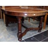 A Victorian mahogany extending dining table, complete with two leaves of varying sizes,