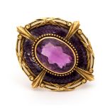 An amethyst and purple enamelled pendant/ brooch,