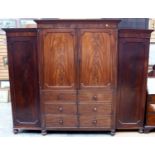 A George III mahogany triple sectioned wardrobe,