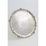 A Victorian silver salver, the pie crust rim chased with rocaille and ribboned foliage,