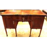 An Edwardian Sheraton Revival strung mahogany pedestal sideboard, serpentine front,