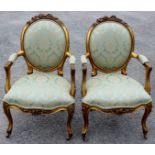 A pair of 19th Century French giltwood carved armchairs, in the Louis XV style,
