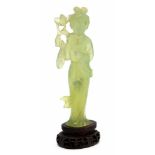 A Japanese carved jade figure of a standing Geisha holding a flower, 20th Century, height 12cm,