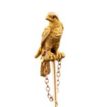 A bird of prey stick pin, featuring an eagle perching on a branch, gem set eyes,