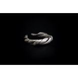 Viking (9th-12th century AD) Silver ring composed of three wide strips plaited together tapering to