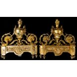 A pair of 19th Century French gilt metal andirons, of Baroque design, flame finials,