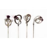 Charles Horner - four silver hat pins, scroll design with amethyst glass thistle finials,