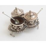 An Indian three piece filigree cruet, the salt, pepper & mustard pot with fruitwood liners,