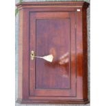 A George III oak hanging corner cupboard, circa 1800,