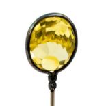 Charles Horner - An Edwardian silver hat pin, set with a fancy facet-cut stone,yellow glass,