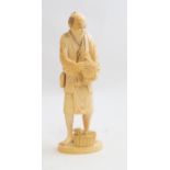 A Japanese ivory okimono of a farmer holding a cockerell, Meiji period, 1868-1912, signed,